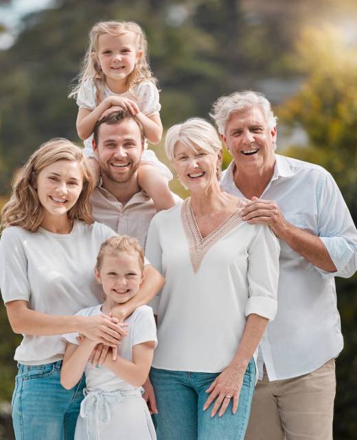 family-dentists-tennessee Mature and young family members outside in the garden. Happy smiling parents relaxing outside with .